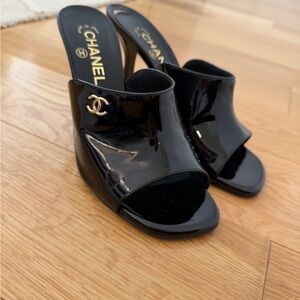 CHANEL Black Patent Leather Mules with Gold Logo